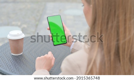 Businesswoman Holding Smartphone with Green Chroma Screen Outdoor