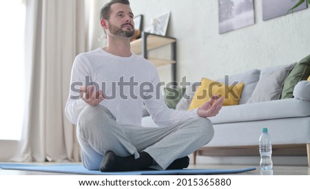 Close up of Mature Adult Man Doing Yoga at Home