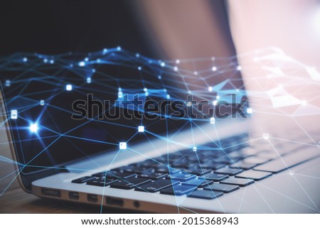 Close up of hands using laptop with creative glowing polygonal mesh on blurry background. Innovation and technology concept. Double exposure