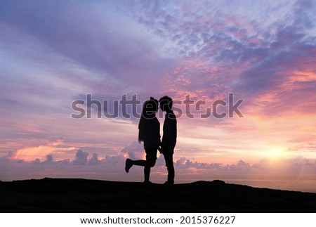 Silhouette of loving couple at sunrise. Love and romance concept.