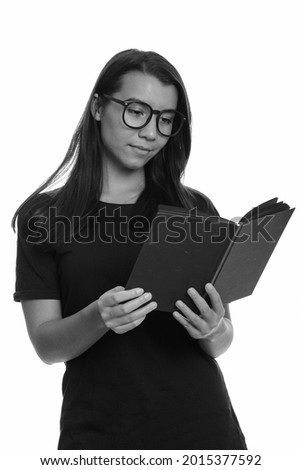Studio shot of young beautiful woman isolated against white background in black and white