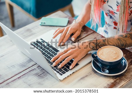 Pretty Young Beauty Woman Using Laptop in cafe, outdoor portrait business woman, hipster style, internet, smartphone, office, Bali Indonesia, holding, mac OS, manager, freelancer  Royalty-Free Stock Photo #2015378501