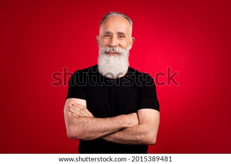 Portrait of attractive cheerful content strong grey-haired man instructor folded arms isolated over bright red color background
