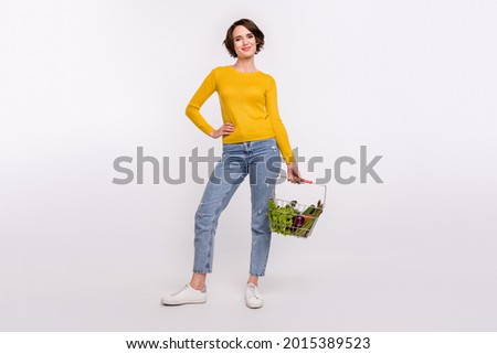 Full body photo of optimistic brunette millennial lady hold food wear shirt jeans isolated on grey color background