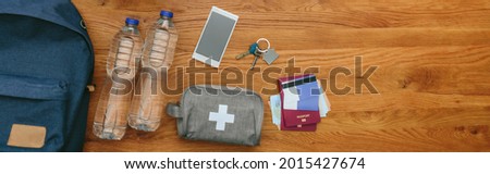 Top view of emergency backpack preparations with necessities