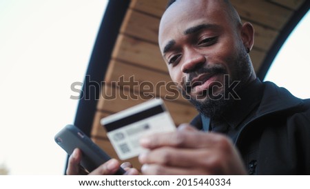 Man holding credit card making e bank online payment. Consumer paying for purchase in app store using smartphone technology.