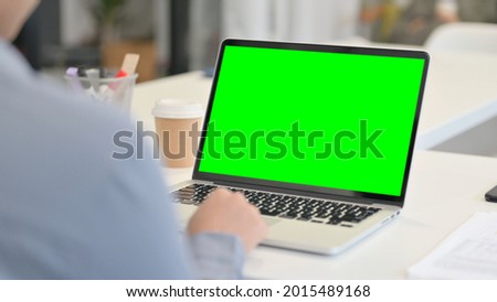 Rear View of African Woman using Laptop with Green Chroma Key Screen