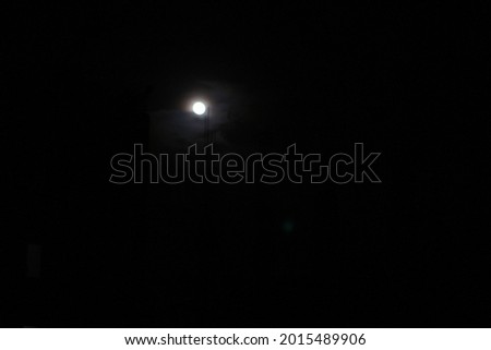 Moon on the dark sky. Real Picture of Moon. The Moon without cloud at night. Serenity nature background, outdoor at gloaming. Beautiful landscape fantasy. Peaceful sky. Minimalist picture of moon.