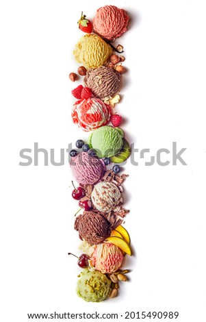 Top view composition of bright multicolored ice cream scoops of various types arranged in vertical row with fruits and berries and nuts