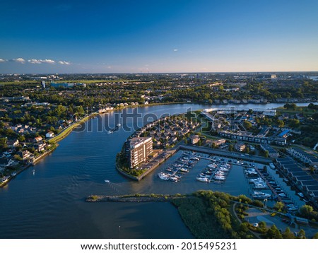 This photograph was taken with a drone. The photograph shows the part of Capelle aan den IJssel in Holland laying against the river the IJssel. Royalty-Free Stock Photo #2015495231