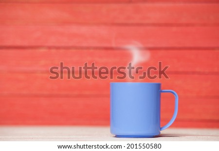 Tea or coffee cup on wooden table.