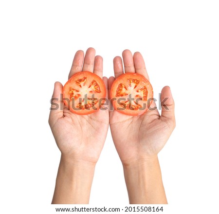 Hand holding a tomato isolated on white background. Fresh vegetable. Raw organic healthy food. Grocery and supermarket cooking and eating.