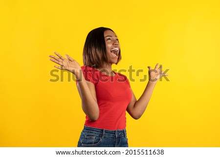 Emotional African American Lady Shouting In Excitement Holding Hands Near Face Standing Over Yellow Studio Background. Side View Shot. Great Offer Advertisement Banner. Omg Concept Royalty-Free Stock Photo #2015511638