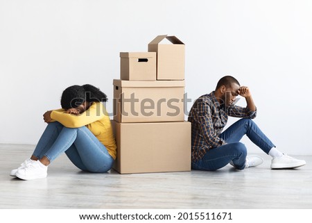 Conflicts During Moving. Sad Black Spouses Sitting Next To Cardboard Boxes In New Flat, Tired African American Couple Suffering Problems With Relocation, Thinking About Divorce, Copy Space