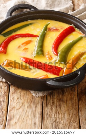 Ema datshi is among the most famous dishes in Bhutanese cuisine it is made from hot chili peppers and cheese closeup in the pan on the table. Vertical
 Royalty-Free Stock Photo #2015515697