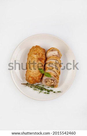 Sliced meat roll on a plate on isolated studio background