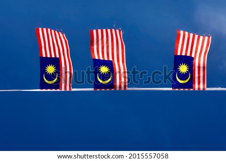 Hanging Malaysia's flag, waving in the wind with clear blue sky
