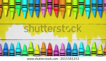 Image of colored pencils in formation on the colored background. Education back to school concept digitally generated image.