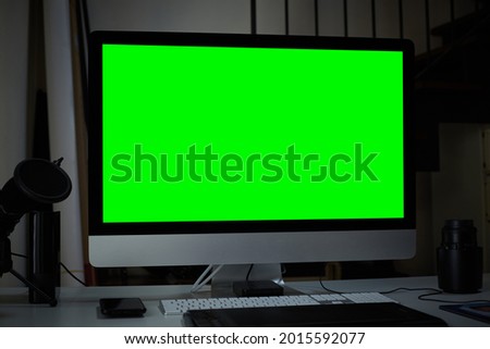 computer on desktop with green screen background