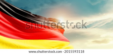 Germany national flag waving in beautiful sky.