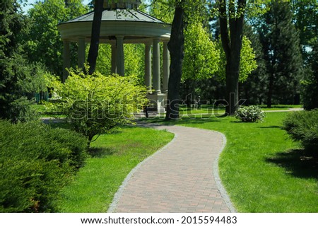 Picturesque view of beautiful park with fresh green grass and trees