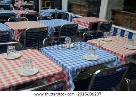 The alternating colors of the tablecloths create a pattern. Royalty-Free Stock Photo #2015606237