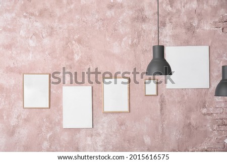 Blank posters on color wall