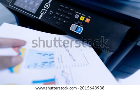 Office worker print paper on multifunction laser printer. Copy, print, scan, and fax machine in office. Modern print technology.  Photocopy machine. Document and paper work. Scanner. Secretary work. Royalty-Free Stock Photo #2015643938