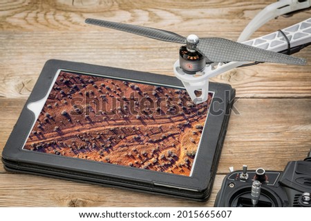 dirt desert road in San Rafael Swell area, Utah - reviewing an aerial image on a digital tablet