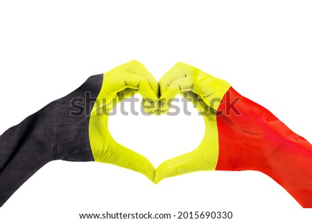 Close up of unknown hands making heart symbol patterned with Belgium flag in the studio. Isolated on white background