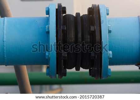 Black rubber expansion joint connecting between 2 piping Royalty-Free Stock Photo #2015720387