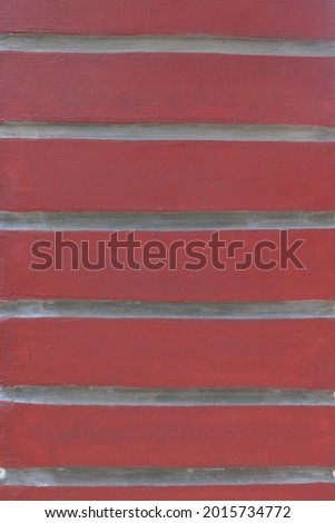 a wallpaper that is red and white with stripes, this is the pattern of a house wall
