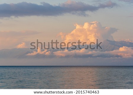 Beautiful view of Albania's coast with amazing clouds as seen during sunset from Corfu island in Greece