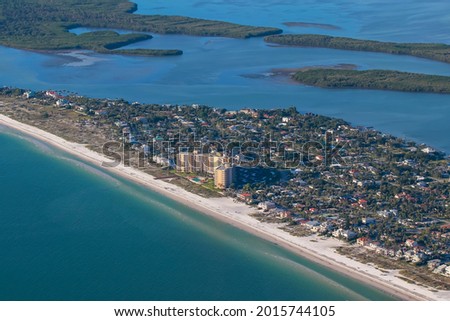 Aerial view of the apartment homes and regular homes by Clear water beach shot from small jet plane.