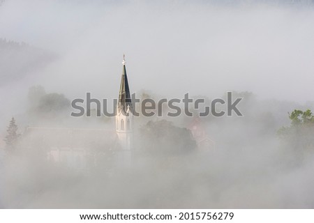 Church lying in misty landscape