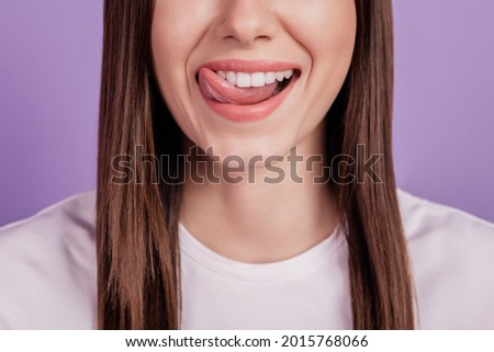 Cropped photo of girl licking lip white healthy teeth isolated on purple background