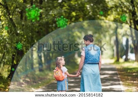 Mom and daughter go to school or walk in fresh air. Ahealthy family with strong immune system. happy parent with child protected from viruses, bacteria. Healthy lifestyle, good immunity, vaccination Royalty-Free Stock Photo #2015814182