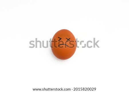 a brown chicken eggs with tired face isolated on white background.