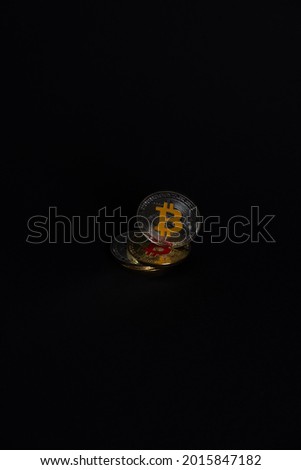 Bitcoin silver coin color with the letter "B" on Yellow color, standing on gold bitcoins coins, in a dark scene. Bitcoin - BTC Bit Coin - Crypto currency.