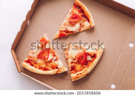 Tasty pizza pieces in delivery box, close up