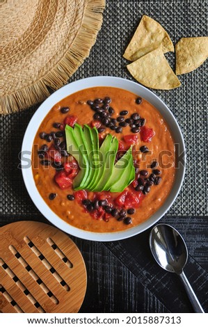 Avocado soup with beans and chips