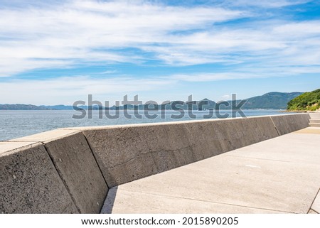 Beautiful Landscape of Seawall or Breakwater in The Blue Sea or Ocean in The Afternoon in Summer, Summer Vacation or Travel Background, Ogijima Island in Kagawa Prefecture in Japan, Nobody Royalty-Free Stock Photo #2015890205
