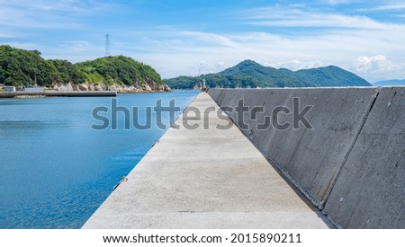 Beautiful Landscape of Seawall or Breakwater in The Blue Sea or Ocean in The Afternoon in Summer, Summer Vacation or Travel Background, Ogijima Island in Kagawa Prefecture in Japan, Nobody Royalty-Free Stock Photo #2015890211