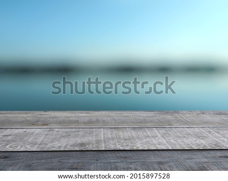 An old plank with a blurry indigo background. Used as a counter for placing products for presentations and advertisements.