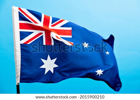 Australia flag waving on blue background.
