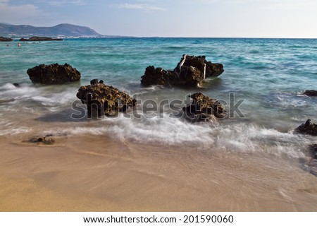 Coast of Crete island in Greece. Red sand beach of famous Falasarna (also known as Falassarna or Phalasarna). Long exposure photo