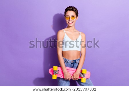 Photo portrait girl in sunglass keeping skateboard looking copyspace isolated pastel violet color background