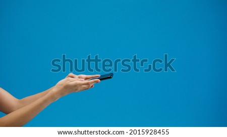Young girl shopping online with mobile and payment order online isolated over blue background. Copy space for place a text, message for advertisement. Advertising area, mockup promotional content.