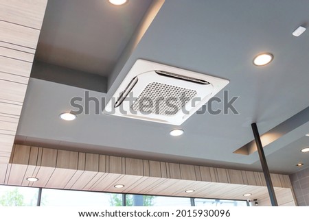 Modern ceiling mounted cassette type air conditioning system in coffee shop Royalty-Free Stock Photo #2015930096