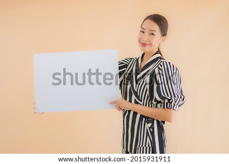 Portrait beautiful young asian woman show empty white billboard paper for text and copy space